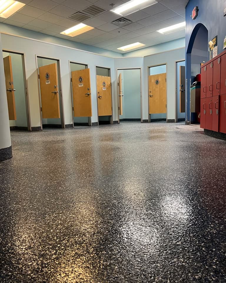 Blue, white, and charcoal metallic epoxy floor in a bright finished interior